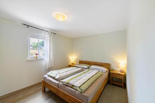 a bedroom with a bed and a window at Ferienhaus Reiseoase in Bützow