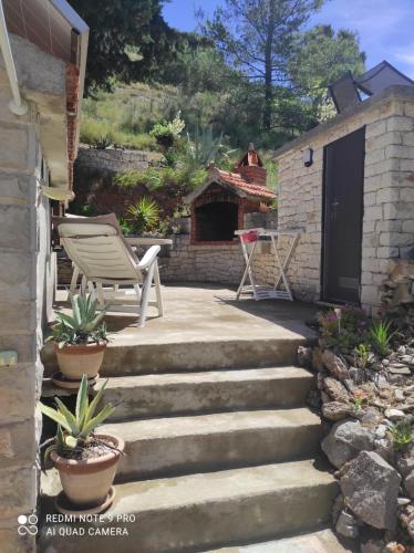 a set of stairs with a chair and a table at House Silvana in Postira