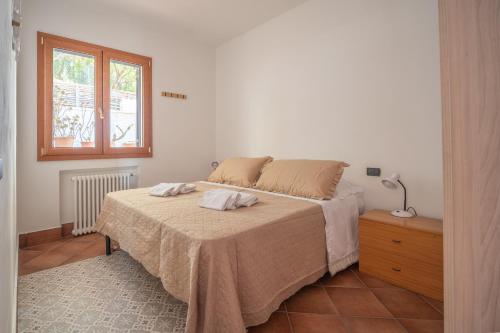 a bedroom with a bed with two towels on it at Breathtaking Sea Views & Jacuzzi in Cefalù in Cefalù