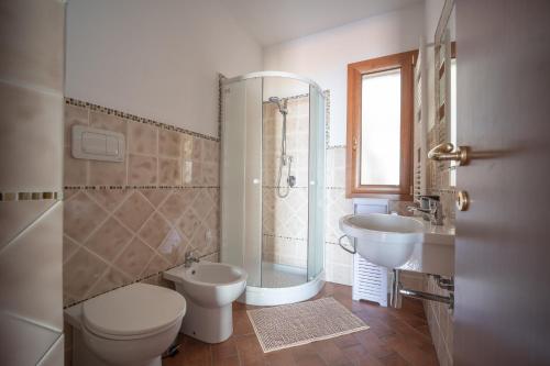 a bathroom with a toilet a sink and a shower at Breathtaking Sea Views & Jacuzzi in Cefalù in Cefalù