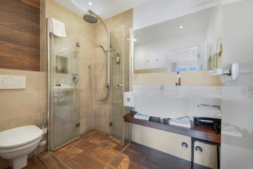 a bathroom with a toilet and a shower at ChiemseeStern Vacation & Recreation Adults Only in Gstadt am Chiemsee