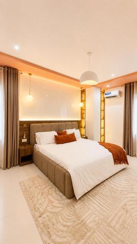 a large bedroom with a large bed and a rug at The Luxe Cottage in Ikeja