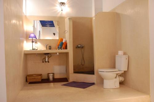 a small bathroom with a toilet and a sink at Riad Dar Soufa in Rabat