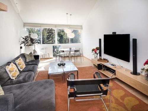 a living room with a couch and a tv at Lionshead Center in Vail