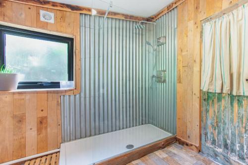 a bathroom with a shower and a window and a tub at 1 Bed in Bream oc-m43316 in Bream