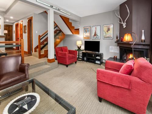 a living room with red furniture and a fireplace at Ptarmigan Townhome 2 in Vail