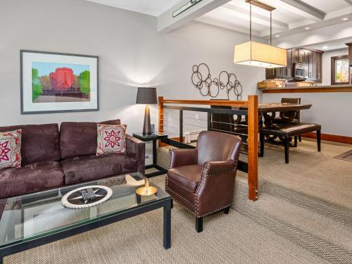 a living room with a couch and a table at Ptarmigan Townhome 2 in Vail