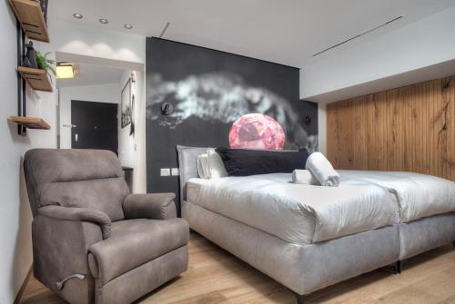 a bedroom with a bed and a chair at דיאמנט - Diamond in Safed
