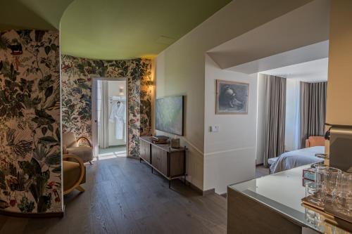 a hotel room with a bed and a living room at Villa MONTGOMMERY in Saint-Jean-le-Thomas