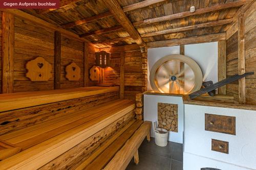 a sauna in a wooden cabin with a fan at Alpensonne Apartments in Bad Wiessee