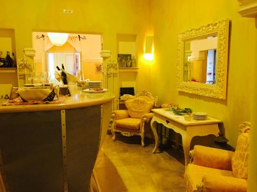 a kitchen with a counter and a chair and a mirror at Albergo Ristorante Egadi in Favignana