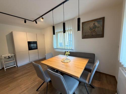 a dining room with a wooden table and chairs at Mountain hOMES in Axams