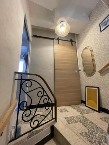 a room with a staircase with a door and a mirror at Giovanna in Marseillan