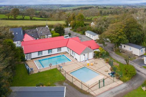 an aerial view of a house with a swimming pool at The Hideaway - Tranquil Glamping Pod in Narberth