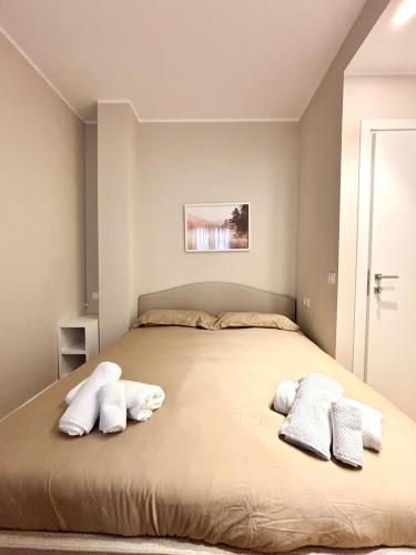 a bedroom with a large bed with two pillows at Alpine Escape 1BR Apartment A in Tarvisio