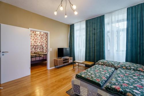 a living room with a bed and a television at Pfarrgarten in Kippenheim