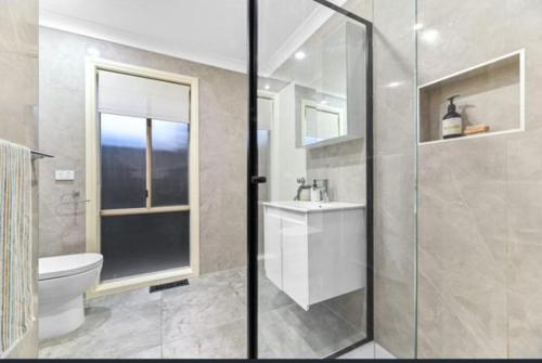 a bathroom with a toilet and a sink and a shower at Seffa 5 vella property in Springvale South