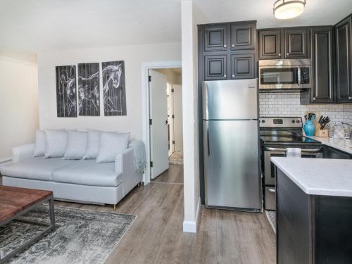 a kitchen and living room with a stainless steel refrigerator at Vail 21 Condo 502 in Vail