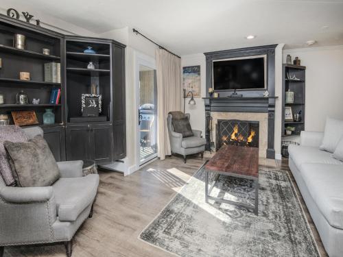 a living room with a fireplace and a tv at Vail 21 Condo 502 in Vail