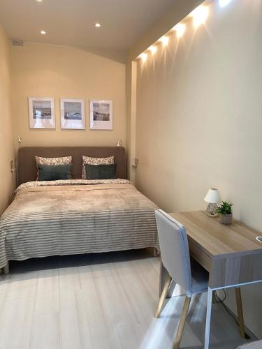a bedroom with a bed and a wooden desk at SeaSand in Jūrmala