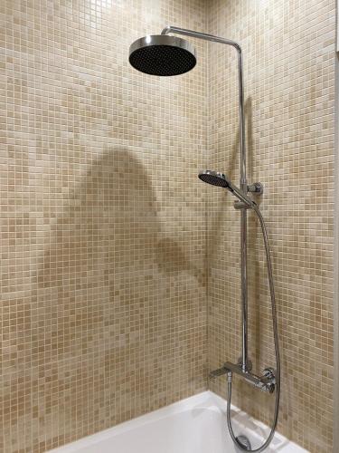 a shower stall in a bathroom with a tub at SeaSand in Jūrmala