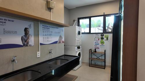 a kitchen with a sink and a microwave at Ip Alto do Ipiranga by Xtay - Estúdio novo com cozinha e a 1 quadra da estação Alto do Ipiranga in São Paulo
