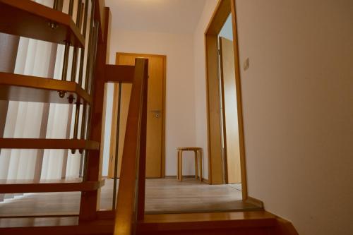 a hallway with a mirror and a stair case at Haus Fährblick in Rees