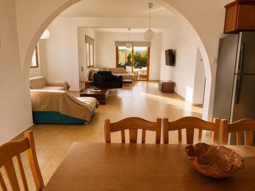 a living room with a dining table and a living room at Mariandy Villa 2 in Coral Bay