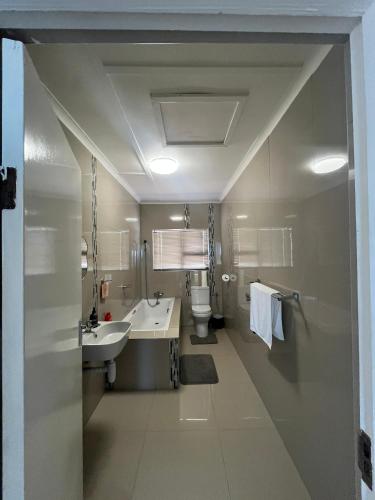 a bathroom with a sink and a toilet at Sunrise Villa Self Catering and Accommodation in Lüderitz
