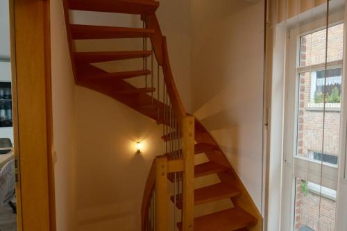 a wooden staircase in a room with a window at Haus Fährblick in Rees