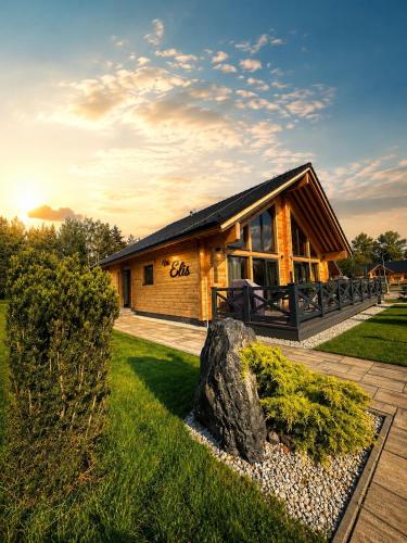a log cabin with a rock in front of it at Vila Elis in Veľká Lomnica