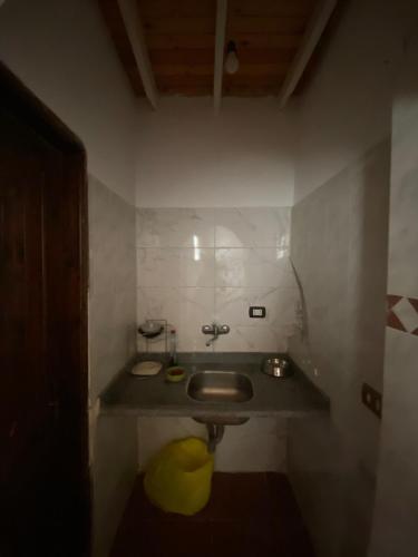 a bathroom with a sink with a yellow object under it at Bedro Private Garden Studio & Outdoor Lounge 1 Min to Sea in Dahab