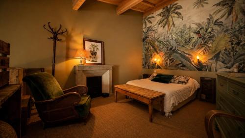 a bedroom with a bed and a table and a fireplace at Studio Rétro in Tournus