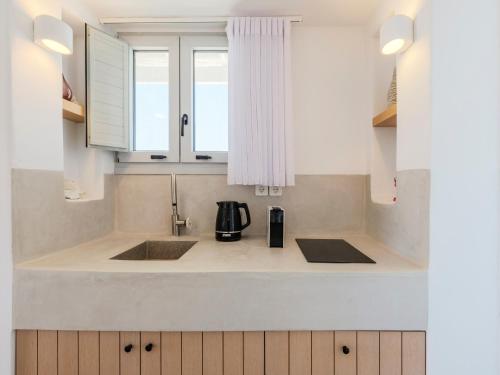 a kitchen counter with two sinks and a window at myMykonos villa II in Platis Gialos