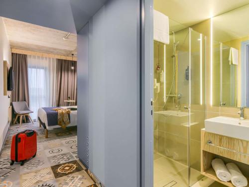 a bathroom with a shower and a sink and a toilet at ibis Styles Bucharest City Center in Bucharest
