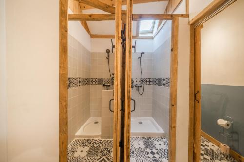 a bathroom with a shower and a tub at Le Mûrier - Grospierres in Grospierres