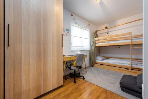 a bedroom with a desk and bunk beds at Holiday Home Marija with pool in Buković