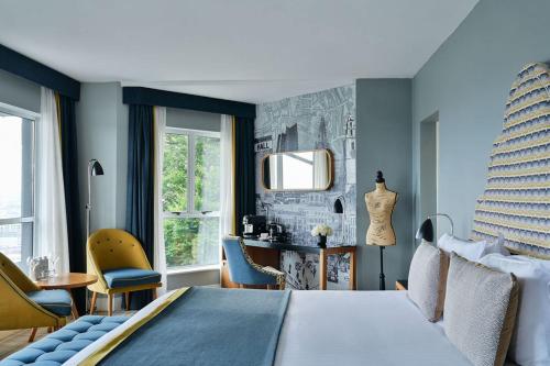 a bedroom with a bed and a table and chairs at The Montenotte Hotel in Cork