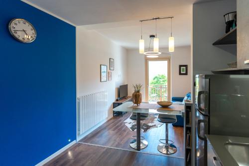 a kitchen with a table and a clock on the wall at Ledro Lake Suites in Ledro