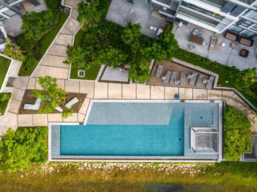 an overhead view of a swimming pool in a building at Cassia Residence by Metrika, Laguna Phuket in Laguna Phuket