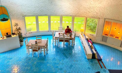 a person sitting at a table in a indoor pool at Posada PuntaDelEste in Punta del Este