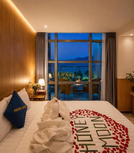 a hotel room with a bed with a flower arrangement on it at Prime New Hotel in Nha Trang