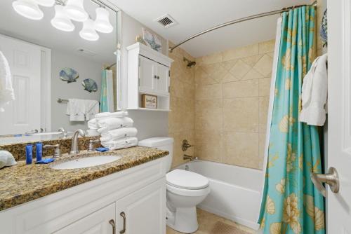 a bathroom with a sink and a toilet and a shower at SeaSpray Riverside 112 in Perdido Key