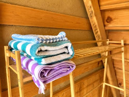 a stack of towels on a rack in a sauna at Kabir's Chalet Shangarh in Shangarh