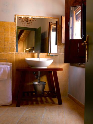 a bathroom with a sink and a mirror at El Lagar del Vero in Huerta de Vero