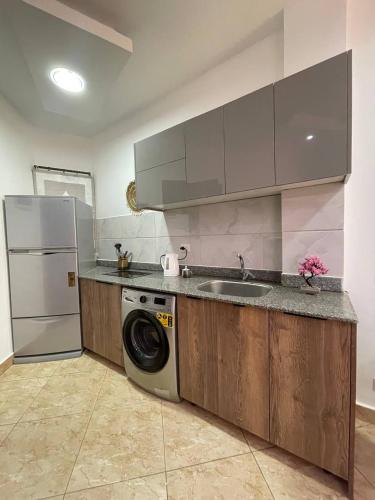 a kitchen with a washing machine and a sink at Jasmine Resort Complex in Sharm El Sheikh
