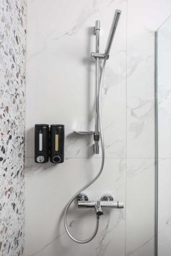 a shower in a bathroom with a glass wall at ELYSIAN luxury apartments in Paliouri