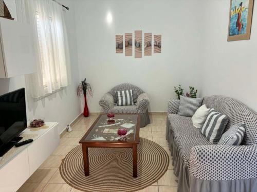 a living room with two couches and a coffee table at Maria's Apartment in Lixouri