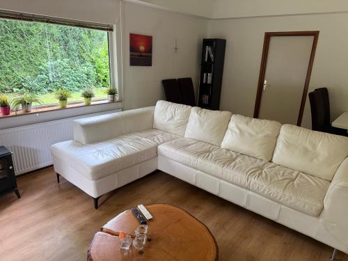 a living room with a white couch and a table at 52 Horalaan in Bennekom