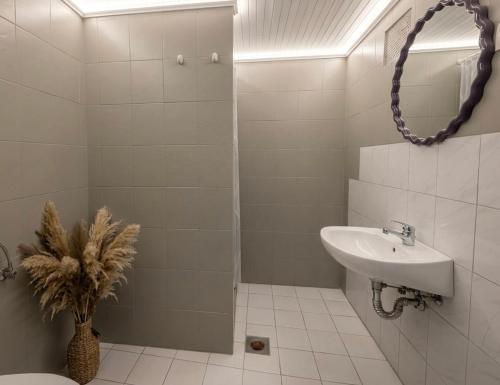 a bathroom with a sink and a toilet and a mirror at Danilo Room 1 in Pula